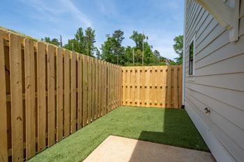 Townhouse with fenced backyard and pet area.
